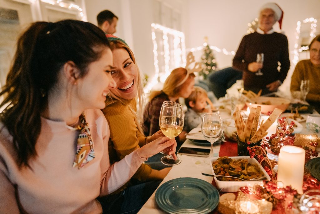 Family enjoying dinner and drinking at Christmas party