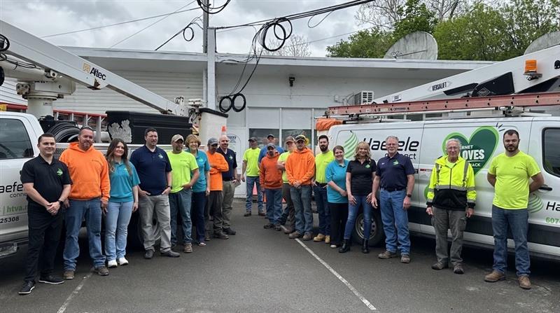 Haefele team lined up in front of their bucket trucks